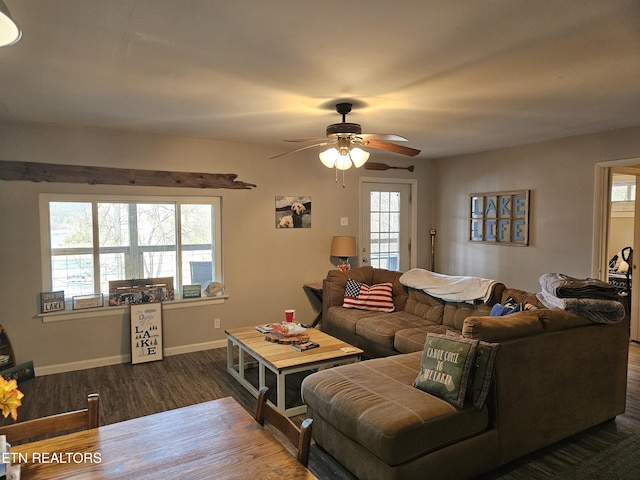 living room featuring dark hardwood / wood-style flooring and ceiling fan