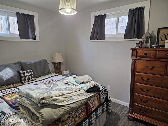 bedroom with dark hardwood / wood-style flooring