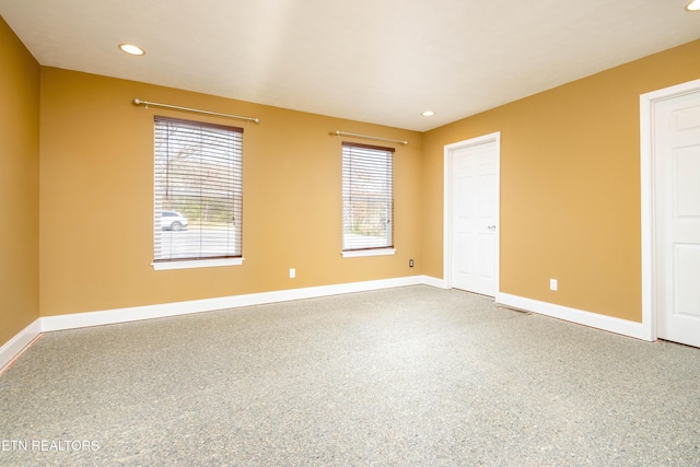 spare room with a wealth of natural light and carpet