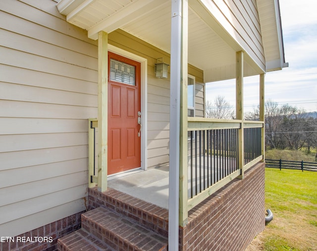 view of exterior entry featuring a porch