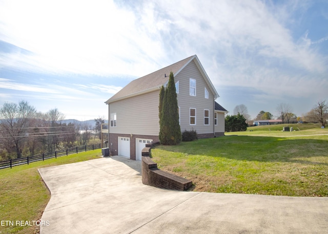 view of property exterior with a lawn, central AC, and a garage