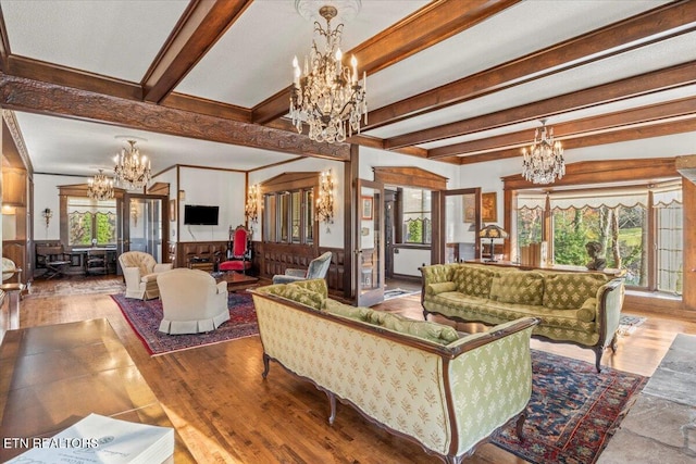 living room featuring hardwood / wood-style flooring, a healthy amount of sunlight, and beamed ceiling