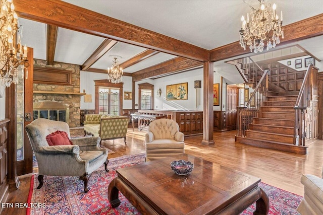 living room with beam ceiling, wood-type flooring, and a fireplace