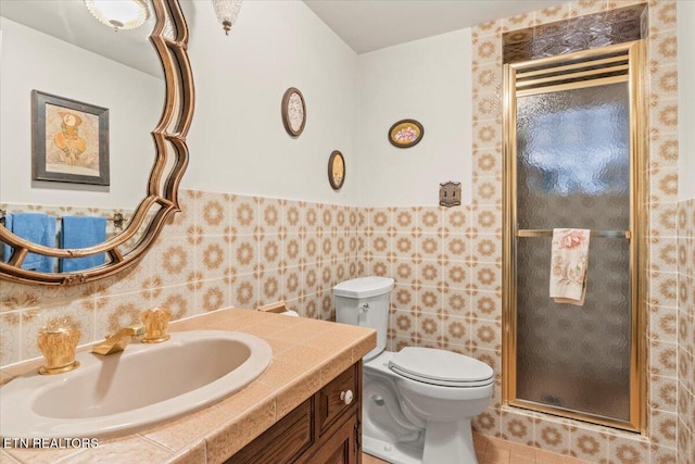 bathroom featuring an enclosed shower, vanity, toilet, and tile walls