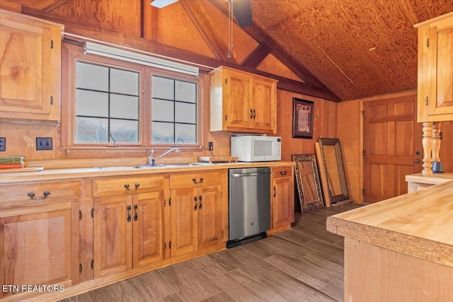 kitchen featuring wood walls, dishwasher, wooden counters, and lofted ceiling