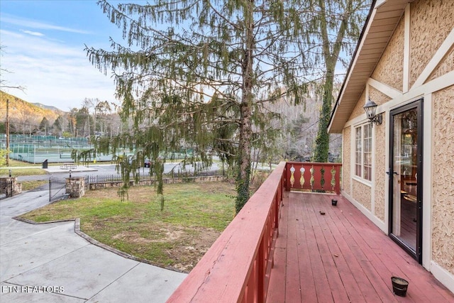 wooden terrace with a water and mountain view