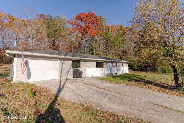 single story home featuring a front yard and a garage