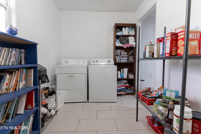 laundry room with light tile patterned flooring and washing machine and clothes dryer