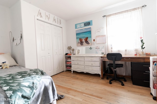 bedroom with light wood-type flooring and a closet