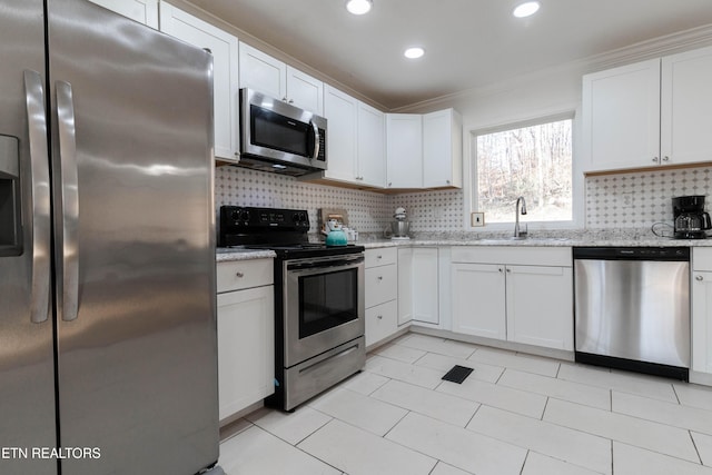 kitchen featuring white cabinetry, sink, and appliances with stainless steel finishes