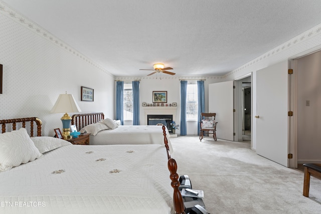 carpeted bedroom featuring ceiling fan and a textured ceiling