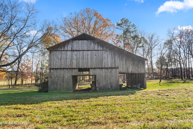 view of outbuilding featuring a yard