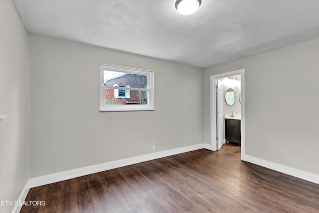 unfurnished room with dark wood-type flooring