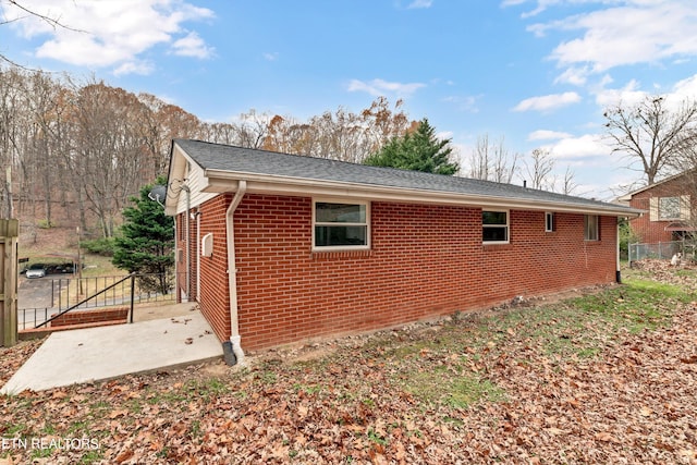 view of side of property with a patio area