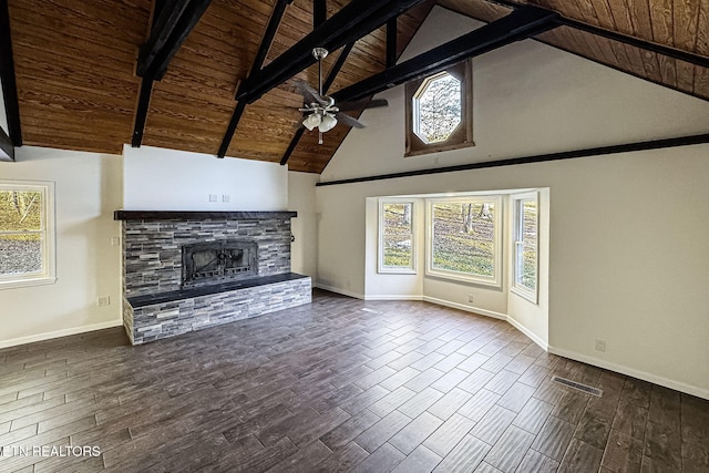 unfurnished living room featuring beamed ceiling, ceiling fan, high vaulted ceiling, wood ceiling, and a stone fireplace