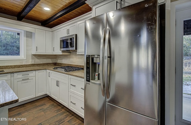 kitchen featuring stainless steel appliances, white cabinets, beamed ceiling, light stone counters, and wood ceiling