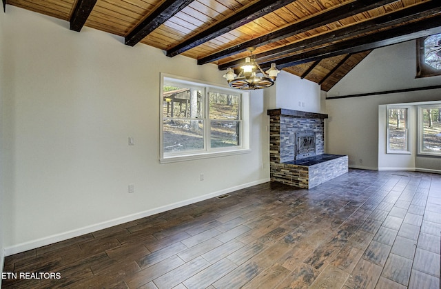 unfurnished living room with a brick fireplace, an inviting chandelier, wooden ceiling, and vaulted ceiling with beams