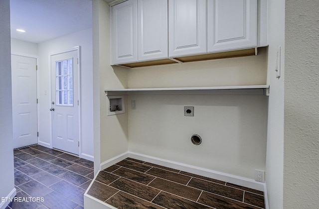 clothes washing area with washer hookup, cabinets, and hookup for an electric dryer