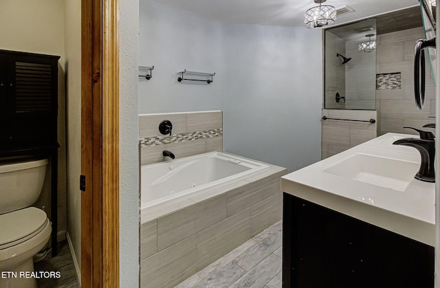 full bathroom featuring a notable chandelier, shower with separate bathtub, vanity, and toilet