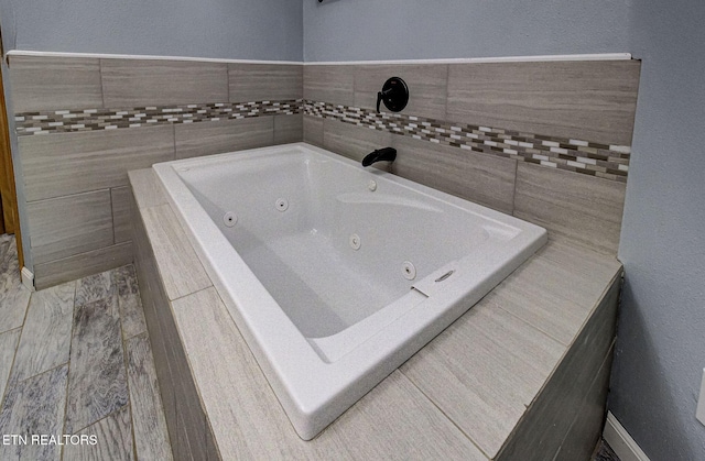 bathroom featuring tiled tub