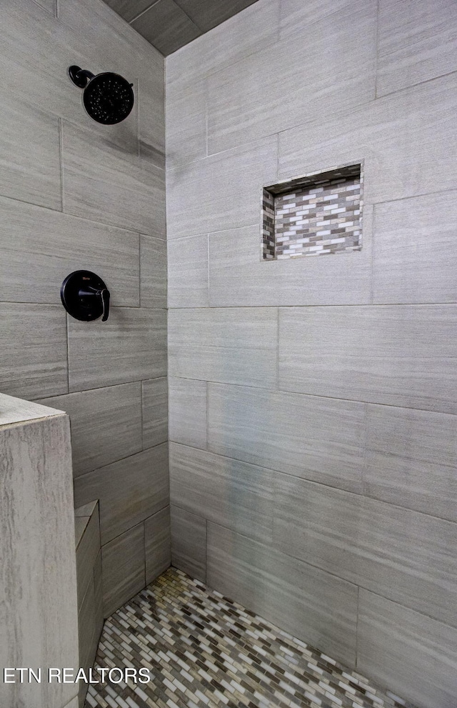 bathroom with tiled shower