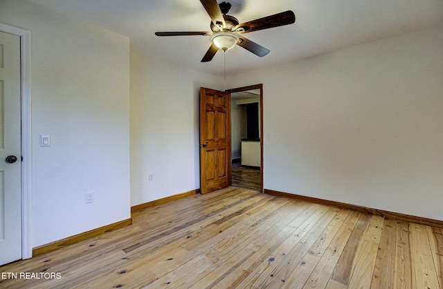 spare room featuring ceiling fan and light hardwood / wood-style flooring