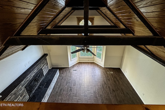 additional living space with ceiling fan, dark hardwood / wood-style flooring, a tile fireplace, and wooden ceiling