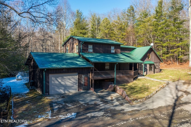 view of front of home featuring covered porch and a garage