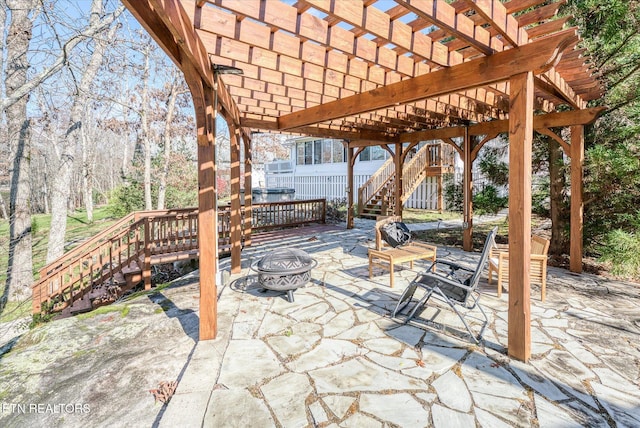 view of patio with a pergola and a fire pit