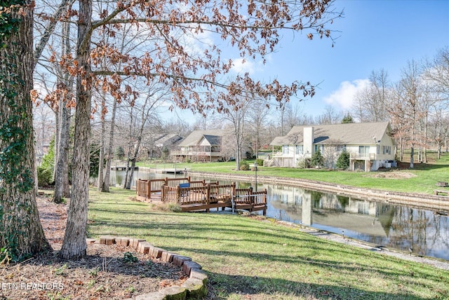 dock area featuring a lawn and a water view