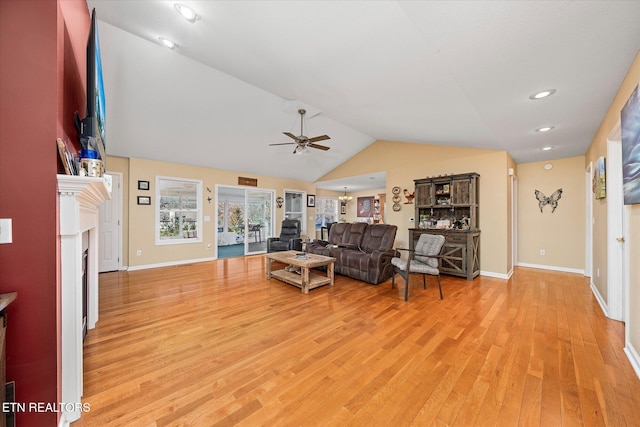 living room with ceiling fan, lofted ceiling, and light hardwood / wood-style flooring