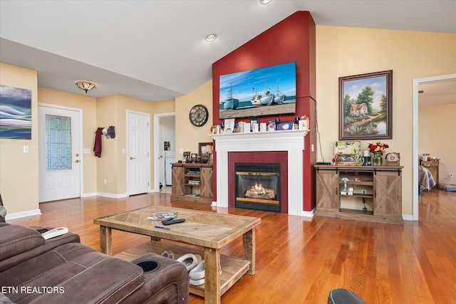 living room with wood-type flooring and lofted ceiling