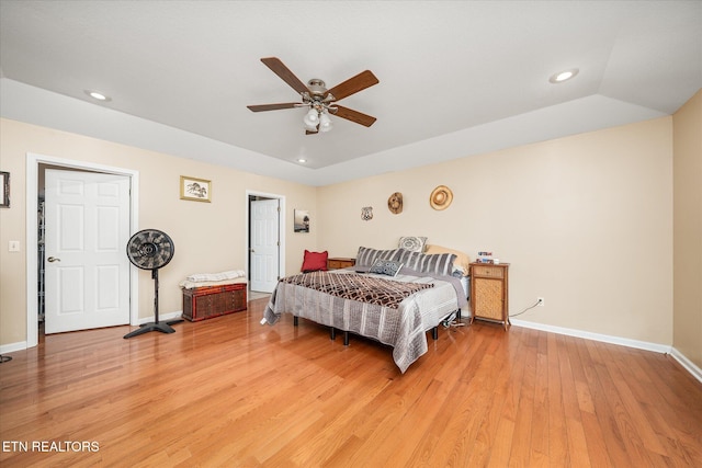 bedroom featuring hardwood / wood-style flooring, ceiling fan, and lofted ceiling