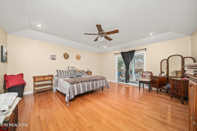 bedroom featuring access to outside, ceiling fan, light hardwood / wood-style flooring, and vaulted ceiling