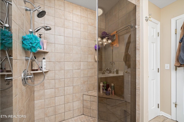 bathroom featuring tiled shower and tile patterned floors