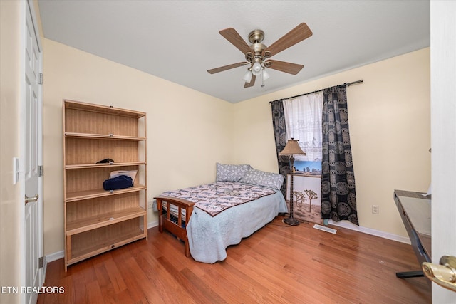 bedroom with wood-type flooring and ceiling fan