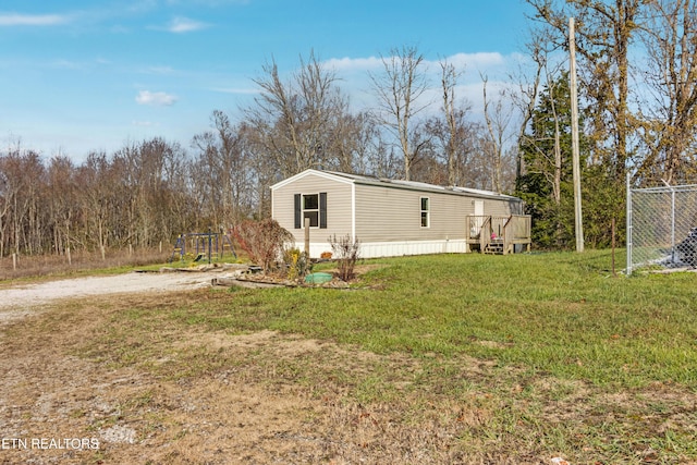 view of side of home with a lawn