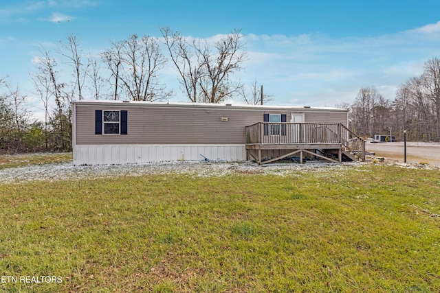 view of front of property with a front lawn and a wooden deck