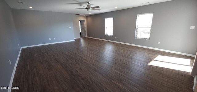 empty room with dark wood-type flooring and ceiling fan