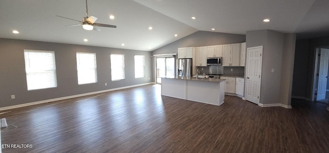 kitchen featuring dark wood-type flooring, appliances with stainless steel finishes, ceiling fan, a kitchen island with sink, and white cabinets