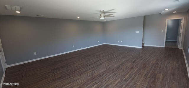 empty room with dark hardwood / wood-style flooring and ceiling fan