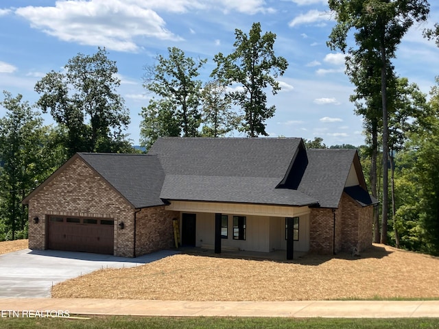 view of front of home with a porch and a garage