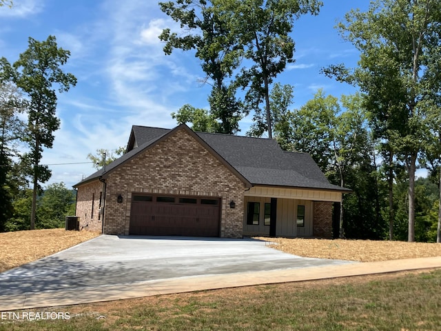 view of front of home with central AC and a garage