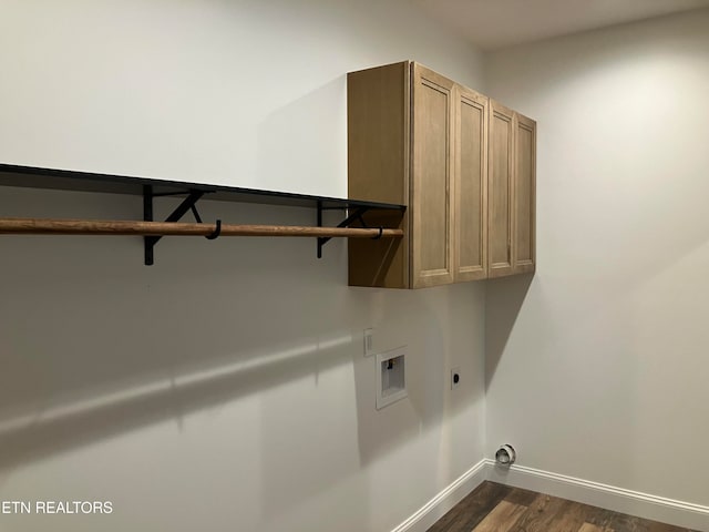 clothes washing area with electric dryer hookup, dark hardwood / wood-style floors, cabinets, and hookup for a washing machine