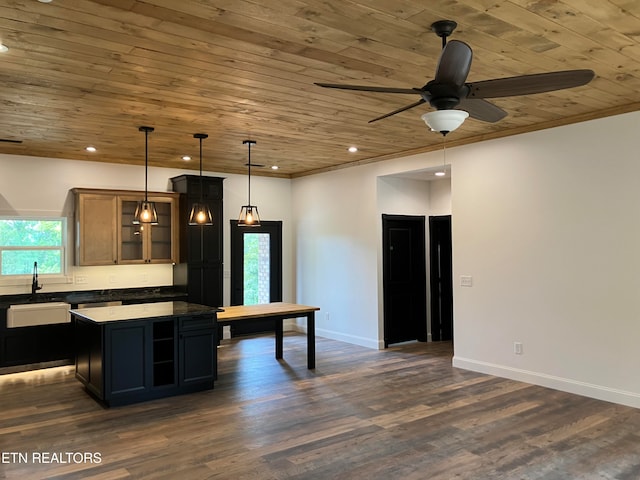 kitchen with pendant lighting, a kitchen island, wood ceiling, and sink