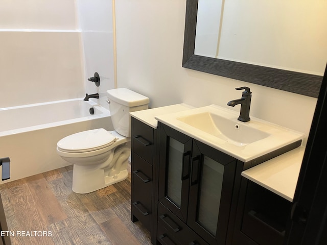 full bathroom with toilet, vanity, tub / shower combination, and hardwood / wood-style flooring