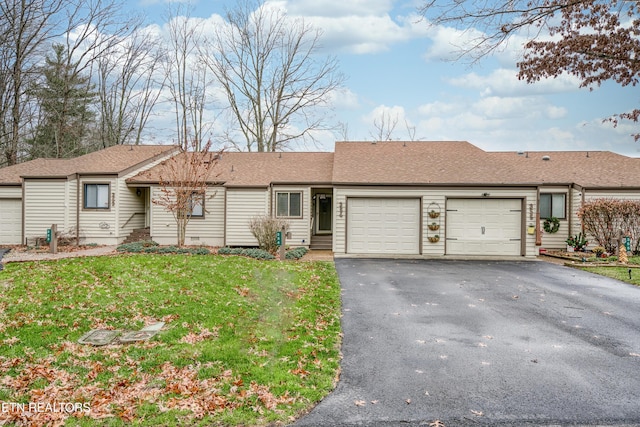 single story home with a front yard and a garage