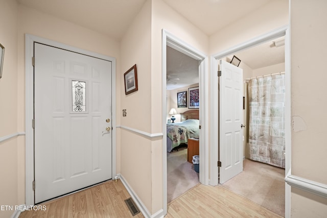 foyer entrance with light hardwood / wood-style flooring