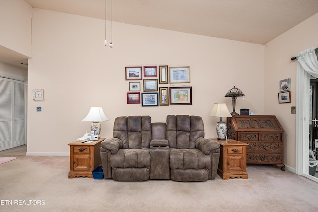 living room with light carpet and high vaulted ceiling