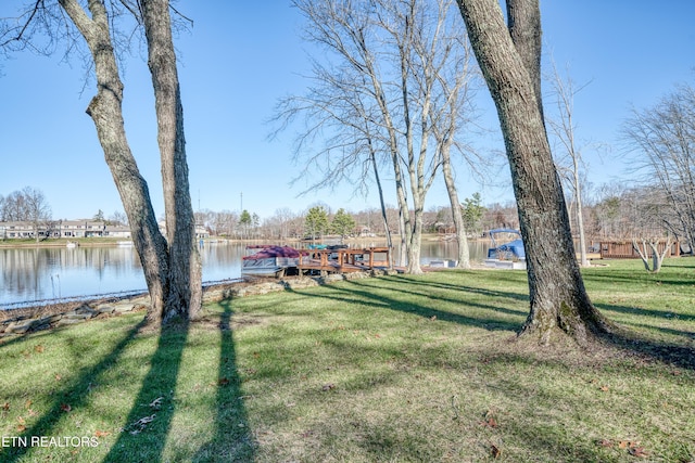 view of yard featuring a dock and a water view